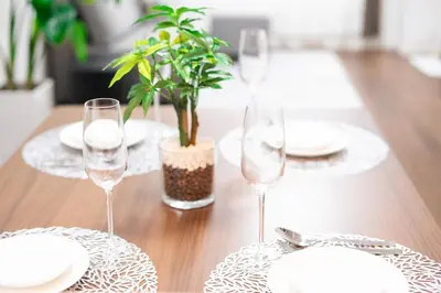 a table with three wine glasses and a potted plant at Sunbright Asakusa 101 in Tokyo