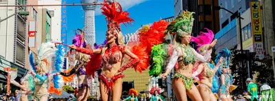 a group of women in colorful costumes in a parade at Sunbright Asakusa 101 in Tokyo