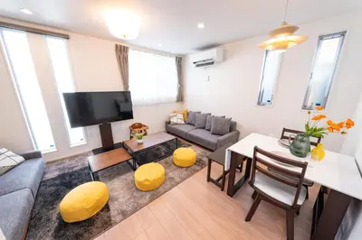 a living room with a couch and a table at Deload Hotel \u6771\u4eac\u3059\u307f\u3060 in Tokyo