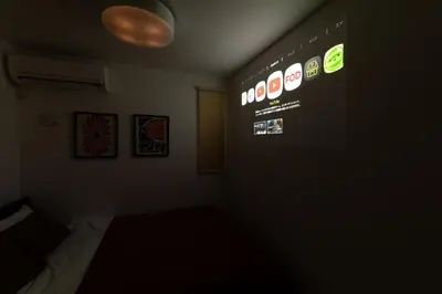 a dark room with a sign on the wall at Deload Hotel \u6771\u4eac\u3059\u307f\u3060 in Tokyo