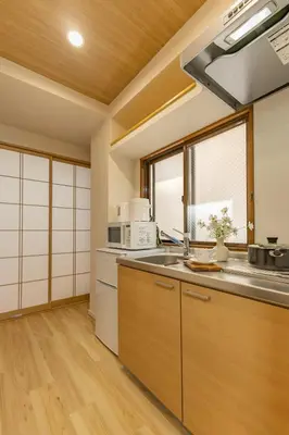 a kitchen with a sink and a microwave at Direct to Shinjuku Higashi-Nakano New APT family First Choice in Tokyo