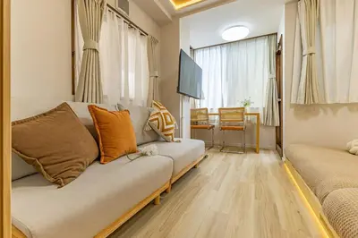a living room with a couch and a television at Direct to Shinjuku Higashi-Nakano New APT family First Choice in Tokyo