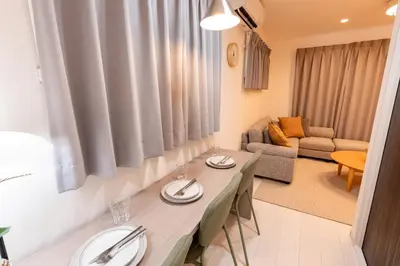a living room with a dining table and a couch at VicoloHouse\u5343\u4f4f\u5927\u6a4b,Family Friendly New House,Near Skytree,12 Guests in Tokyo