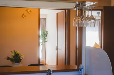 a mirror above a kitchen counter with a sink at KR Fit Stay Kami-Itabashi in Tokyo