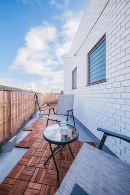 a patio with a table and a chair on a balcony at KR Fit Stay Kami-Itabashi in Tokyo