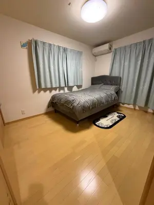 a bedroom with a bed and a wooden floor at gt house in Tokyo
