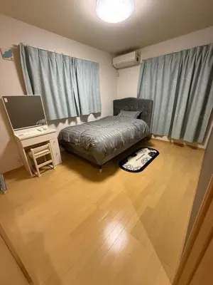 a bedroom with a bed and a desk with a television at gt house in Tokyo