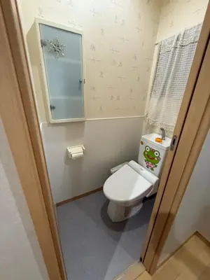 a small bathroom with a toilet and a mirror at gt house in Tokyo