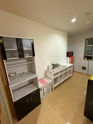 a large kitchen with a stove and a sink at gt house in Tokyo