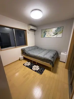 a small bedroom with a bed in a room at gt house in Tokyo