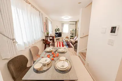 a dining room with a table with plates and bowls at Minami Inn 3 bed rooms Villa 8 minutes walk from JR line Koiwa station For Family in Tokyo