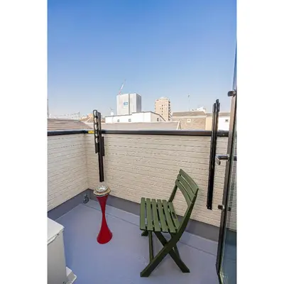 a green chair and a red spoon on a balcony at Minami Inn 3 bed rooms Villa 8 minutes walk from JR line Koiwa station For Family in Tokyo