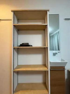 a closet with wooden shelves and a sink at 15 min to Shinjuku, 4 min walk to nearest station, quiet brand-new residence in Tokyo