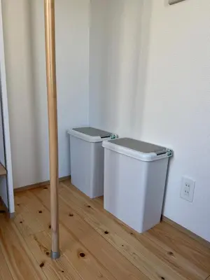 two white trash cans in a corner of a room at 15 min to Shinjuku, 4 min walk to nearest station, quiet brand-new residence in Tokyo