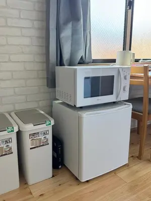 a microwave sitting on top of two refrigerators at 15 min to Shinjuku, 4 min walk to nearest station, quiet brand-new residence in Tokyo