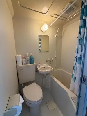 a small bathroom with a toilet and a sink at Kinjiro Hotel in Tokyo