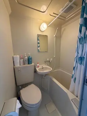 a small bathroom with a toilet and a sink at Kinjiro Hotel in Tokyo