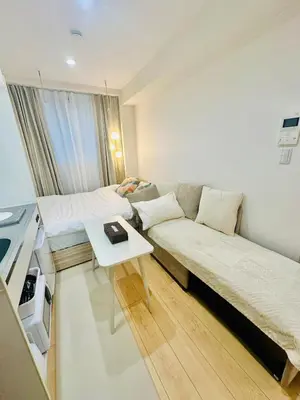 a room with a couch and a bed and a table at jlb\u30b0\u30e9\u30f3\u30a8\u30af\u30ea\u30e5\u521d\u53f0 102 in Tokyo
