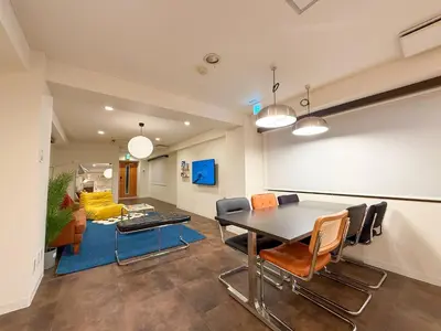 a dining room with a table and chairs and a couch at 52 House Nishi-Shimbashi in Tokyo