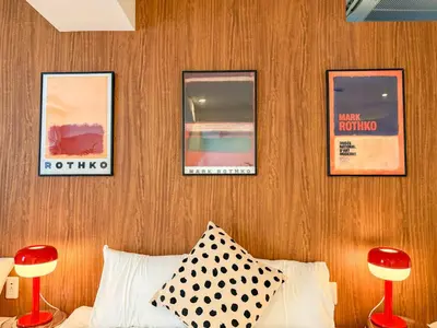 a bedroom with a wooden wall with pictures on it at 52 House Nishi-Shimbashi in Tokyo