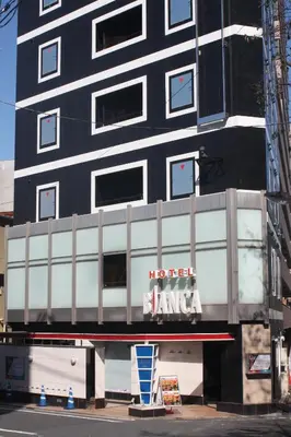 a black building with a hotel island sign on it at Hotel Bianca Due (Adult Only) in Tokyo