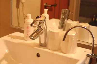 a bathroom sink with two bottles and a faucet at Hotel Bianca Due (Adult Only) in Tokyo