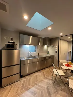 a kitchen with a stainless steel refrigerator and a sink at Koenji Designer house 50m2, 5min to Shinjuku in Tokyo