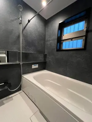 a white bath tub in a bathroom with a window at Koenji Designer house 50m2, 5min to Shinjuku in Tokyo