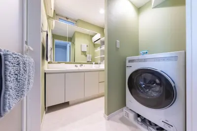 a washing machine in a bathroom with a sink at Mic House SHINJUKU in Tokyo