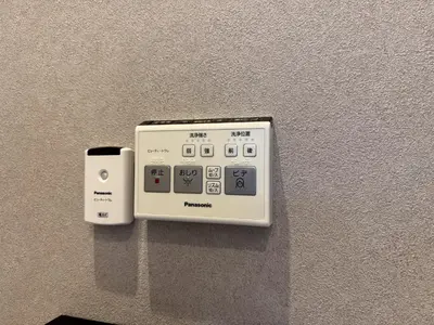 a remote control sitting on a wall next to at Mic House SHINJUKU in Tokyo