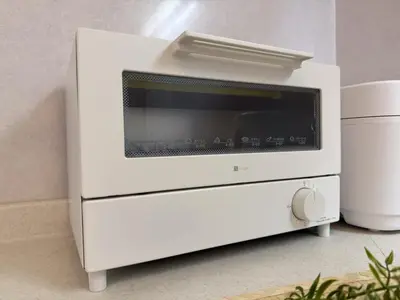 a white microwave oven sitting on top of a counter at Mic House SHINJUKU in Tokyo