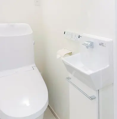 a white bathroom with a toilet and a sink at 5 min to JR Tabata Station Entire 3BR House 82sqm Sleeps 5 Hot Tub Newly Built in Tokyo