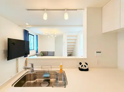 a kitchen with a sink and a panda bear on the counter at 5 min to JR Tabata Station Entire 3BR House 82sqm Sleeps 5 Hot Tub Newly Built in Tokyo