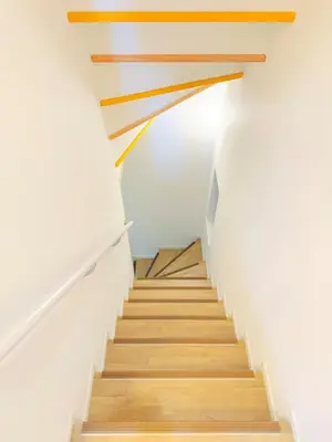 a staircase with wooden railings in a house at 5 min to JR Tabata Station Entire 3BR House 82sqm Sleeps 5 Hot Tub Newly Built in Tokyo