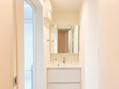a bathroom with a sink and a mirror at 5 min to JR Tabata Station Entire 3BR House 82sqm Sleeps 5 Hot Tub Newly Built in Tokyo
