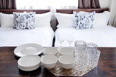 a coffee table with plates and glasses and a couch at Clair US Tokyo in Tokyo