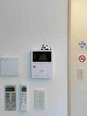 a microwave on a wall with a dog sticker on it at Newly Built Detached Villa 5 min walk to JR Tabata Station Yamanote Line in Tokyo