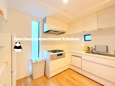 a kitchen with white cabinets and a sink at Newly Built Detached Villa 5 min walk to JR Tabata Station Yamanote Line in Tokyo
