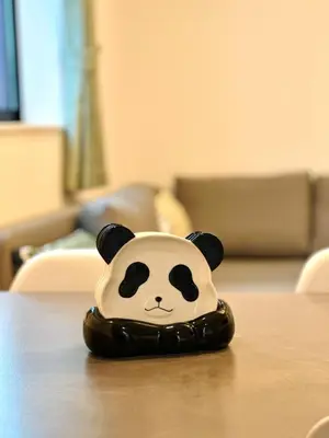 a toy panda bear is sitting on a table at Newly Built Detached Villa 5 min walk to JR Tabata Station Yamanote Line in Tokyo