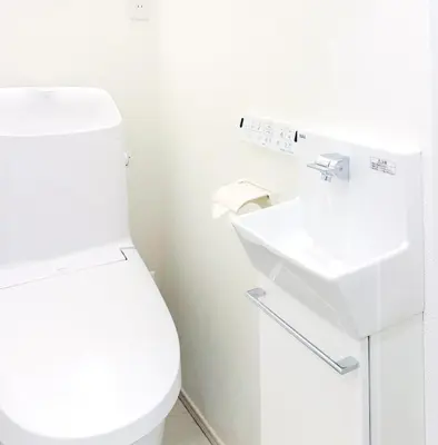 a white bathroom with a toilet and a sink at Newly Built Detached Villa 5 min walk to JR Tabata Station Yamanote Line in Tokyo