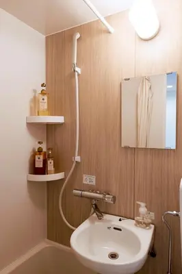 a bathroom with a sink and a shower at Astra house in Tokyo