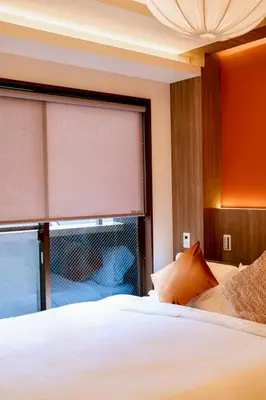 a bedroom with a white bed and a window at Astra house in Tokyo