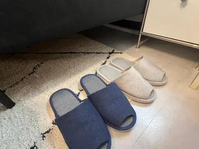 a group of shoes and slippers on a floor at Kuro House - In the middle of Hiro, Omotesando, Roppongi in Tokyo