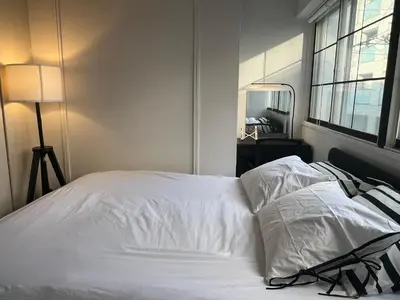 a white bed with two pillows in a bedroom at Kuro House - In the middle of Hiro, Omotesando, Roppongi in Tokyo