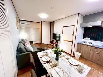 a living room with a table and a couch at Minami Shinagawa House \u5357\u54c1\u5dddHouse in Tokyo