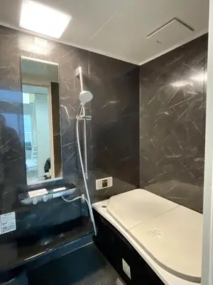 a bathroom with a bed and a mirror at CIENtONCE BLD in Tokyo