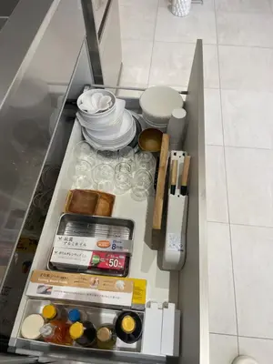 a drawer in a cabinet filled with food and drinks at CIENtONCE BLD in Tokyo