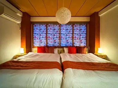 two beds in a room with a window at \u6e0b\u8c37\u897f\u5ddd\u30d3\u30eb in Tokyo