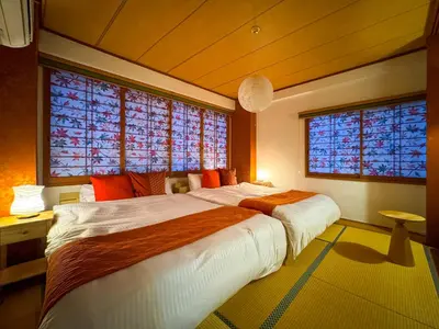 a bedroom with a large bed and two windows at \u6e0b\u8c37\u897f\u5ddd\u30d3\u30eb in Tokyo