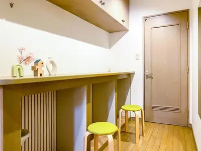 a kitchen with two yellow stools and a counter at \u6e0b\u8c37\u897f\u5ddd\u30d3\u30eb in Tokyo
